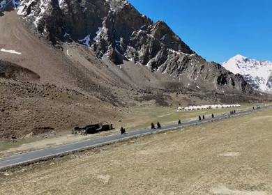 Aerial View of Tourists bike Riding Through Himalayan Valley in Ladakh India