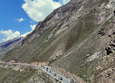 Aerial View of Tourists bike Riding Through Himalayan Valley in Ladakh India