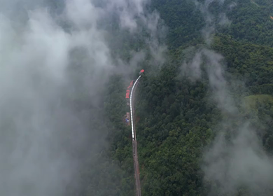 Aerial View of Train Passing Through Misty Forest in Kanyakumari Tamil Nadu
