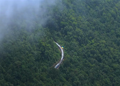 Aerial View of Train Passing Through Misty Forest in Kanyakumari Tamil Nadu