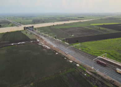 Aerial View of Train Passing Through Agricultural Fields in Tumkur India