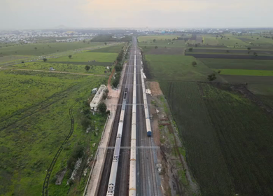 Aerial View of Train Passing Through Agricultural Fields in Tumkur India