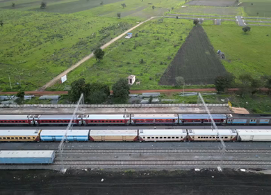 Aerial View of Train Passing Through Agricultural Fields in Tumkur India