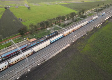 Aerial View of Train Passing Through Agricultural Fields in Tumkur India