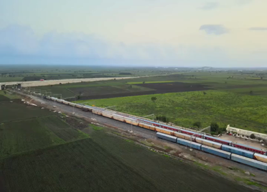 Aerial View of Train Passing Through Agricultural Fields in Tumkur India