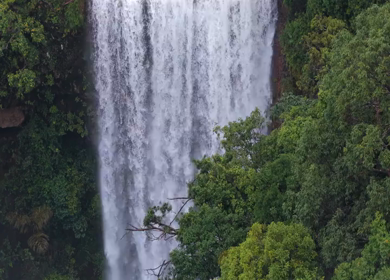 Aerial View of Waterfall in Misty Green Hills of Maharashtra