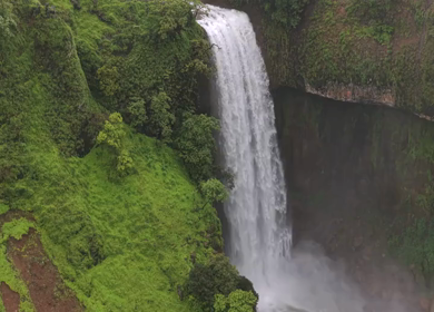 Aerial View of Waterfall in Misty Green Hills of Maharashtra