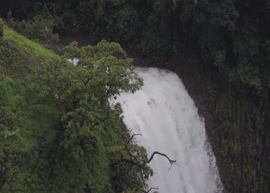 Aerial View of Waterfall in Misty Green Hills of Maharashtra