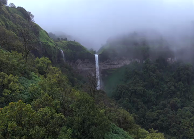 Aerial View of Waterfall in Misty Green Hills of Maharashtra