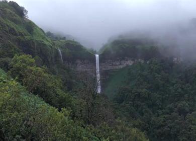 Aerial View of Waterfall in Misty Green Hills of Maharashtra