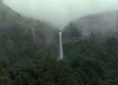 Aerial View of Waterfall in Misty Green Hills of Maharashtra
