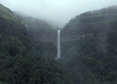 Aerial View of Waterfall in Misty Green Hills of Maharashtra