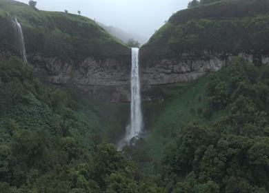 Aerial View of Waterfall in Misty Green Hills of Maharashtra