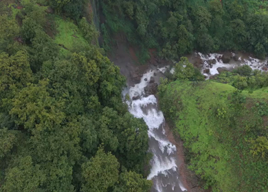Aerial View of Waterfall in Misty Green Hills of Maharashtra