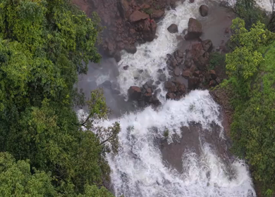 Aerial View of Waterfall in Misty Green Hills of Maharashtra