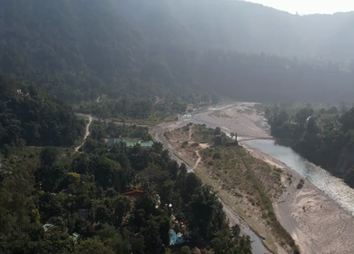 Aerial drone view of Jim Corbett National Park river valley, dense forest and scenic Uttarakhand landscape, India