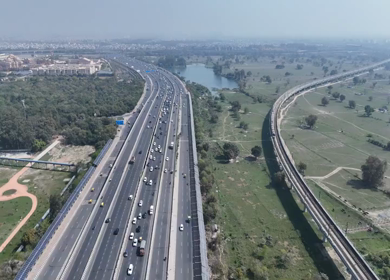Aerial drone view of NH 24 highway with Metro in New Delhi India