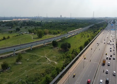 Aerial drone view of NH 24 highway with Delhi Metro in New Delhi India