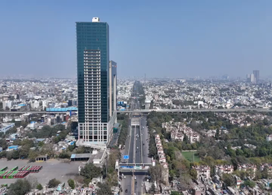 Aerial drone view of Sector 16 Noida Film City with modern office tower and metro in India