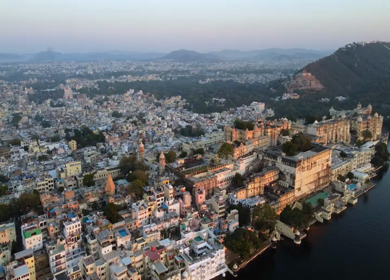 Aerial evening view of City Palace and Lake Pichola in Udaipur Rajasthan India