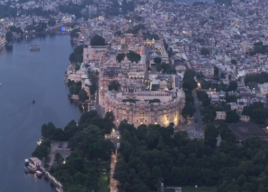 Aerial evening view of City Palace and Lake Pichola in Udaipur Rajasthan India