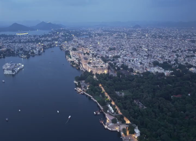 Aerial evening view of City Palace and Lake Pichola in Udaipur Rajasthan India
