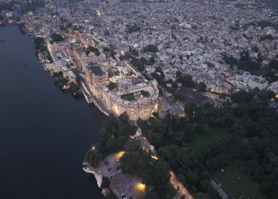 Aerial evening view of City Palace and Lake Pichola in Udaipur Rajasthan India