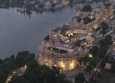 Aerial evening view of City Palace and Lake Pichola in Udaipur Rajasthan India