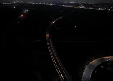 Aerial night shot of Delhi Metro train crossing elevated track in New Delhi India