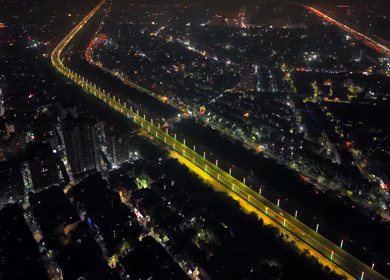 Aerial night view of illuminated highway and cityscape in New Delhi India