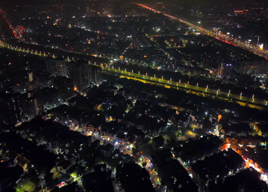 Aerial night view of illuminated highway and cityscape in New Delhi India