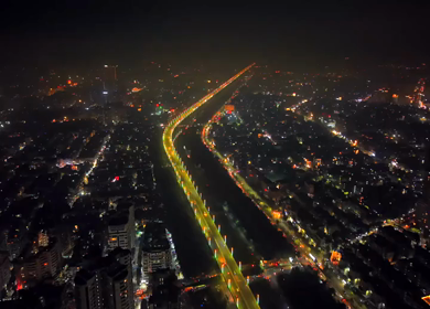 Aerial night view of illuminated highway and cityscape in New Delhi India