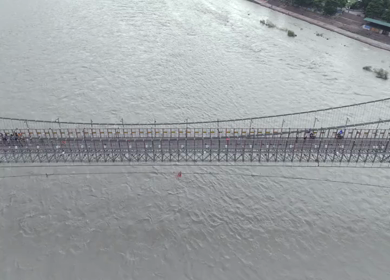 Aerial shot of Janki Setu suspension bridge over Ganges River in Rishikesh India