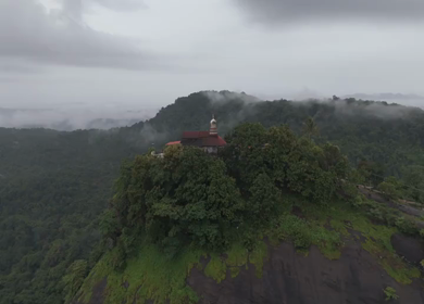 Aerial shot of Karinjeshwara Temple on rocky hilltop in Karnataka India