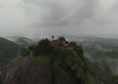 Aerial shot of Karinjeshwara Temple on rocky hilltop in Karnataka India