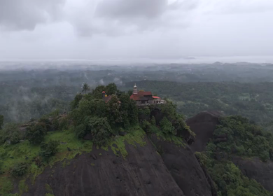 Aerial shot of Karinjeshwara Temple on rocky hilltop in Karnataka India