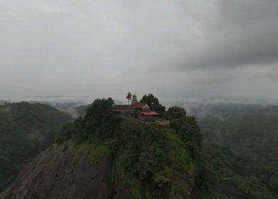 Aerial shot of Karinjeshwara Temple on rocky hilltop in Karnataka India
