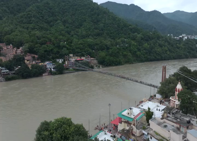 Aerial shot of Ram Jhula suspension bridge over Ganges River in Rishikesh India