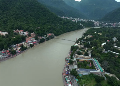 Aerial shot of Ram Jhula suspension bridge over Ganges River in Rishikesh India