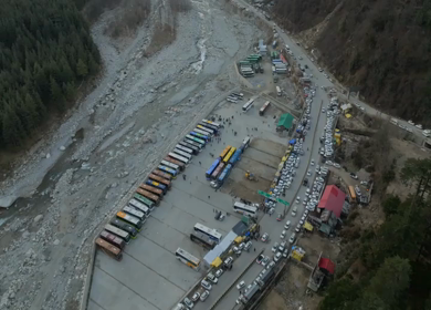 Aerial view of bus parking and traffic near river valley in Manali Himachal Pradesh India