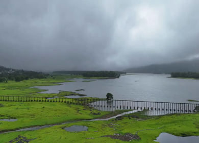 Aerial drone view of lush green hills and reservoir in Maharashtra India