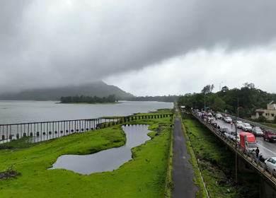 Aerial drone view of lush green hills and reservoir in Maharashtra India