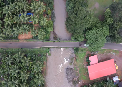 Aerial view of river and road bridge,Gangavali Bridge surrounded by coconut trees in Gokarna Karnataka India