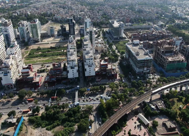 An aerial Drone shot of Delhi metro entering metro station
