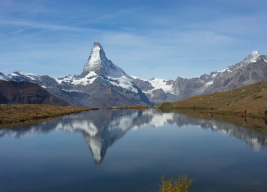 An aerial shot of Matterhorn peak reflected in Stellisee Lake In Zermatt, Switzerland