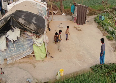An aerial shot of poor kids playing in a slum in Delhi