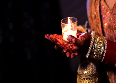 A shot of Indian Bride holding a Candle Diya to pose for her photoshoot at her Indian Wedding