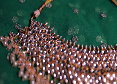 A slow motion shot of elegant Indian bridal jewelry featuring an ornate necklace, bangles, earrings, and headpiece