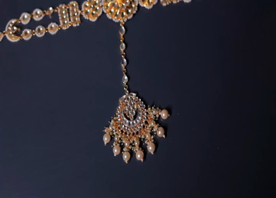 A slow motion shot of elegant Indian bridal jewelry featuring an ornate necklace, bangles, earrings, and headpiece