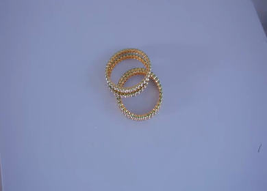 A slow motion shot of elegant Indian bridal jewelry featuring an ornate necklace, bangles, earrings, and headpiece